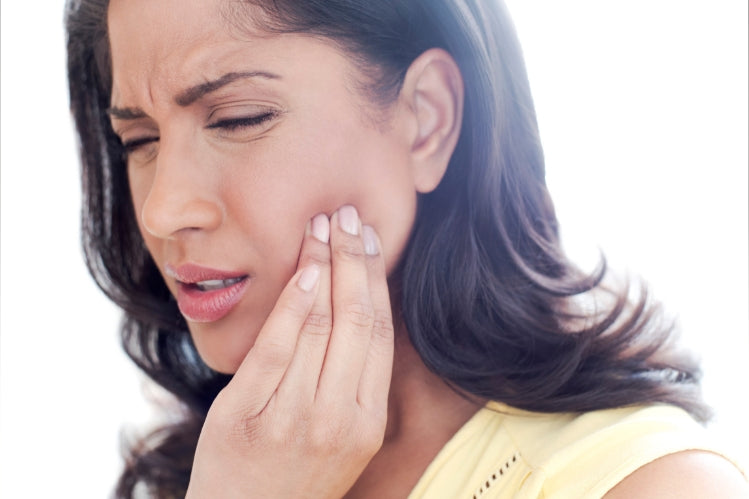  Woman suffering from TMJ pain